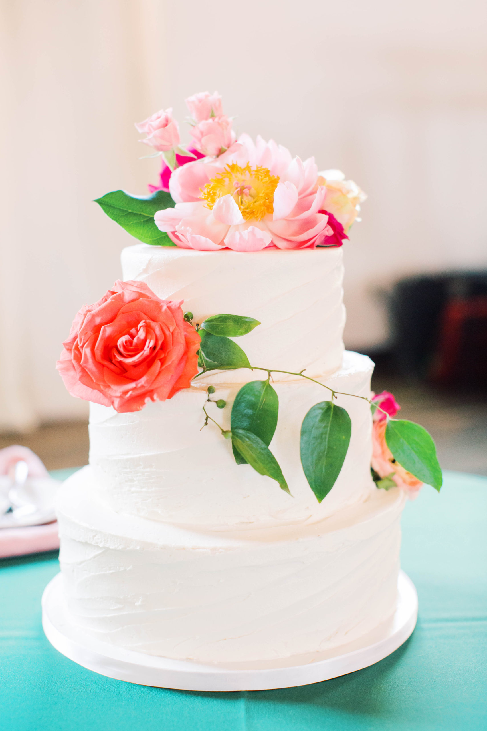 white wedding cake with pink florals for spring wedding